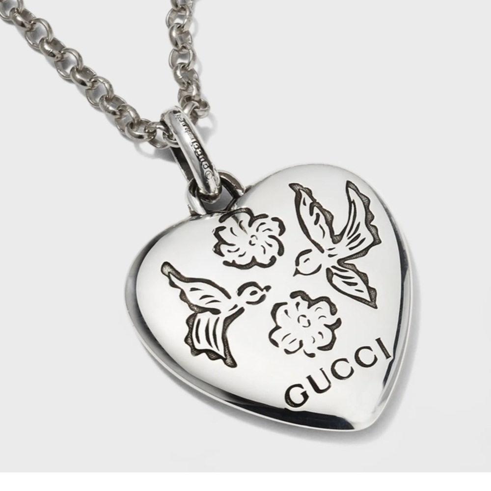 Gucci blind for love necklace features a double-sided heart. Silver necklace